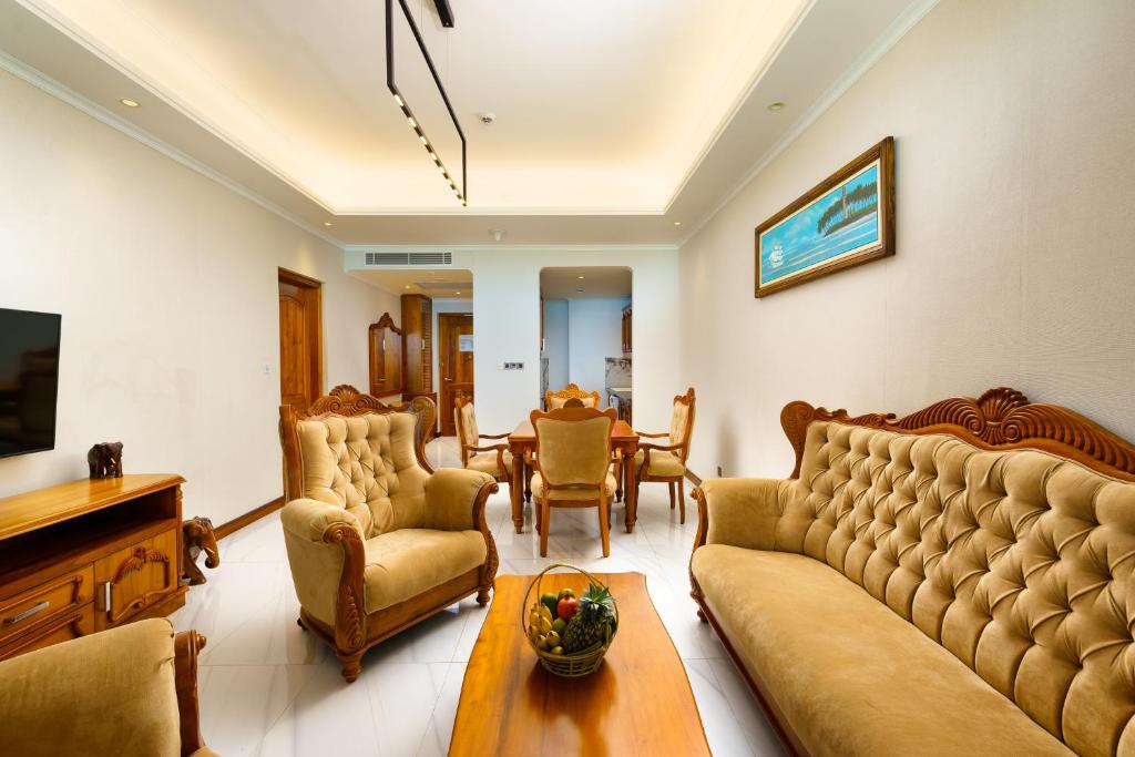 a living room with a couch and a table at Araliya Beach Resort & Spa Unawatuna- Where you meet the sea all year in Unawatuna