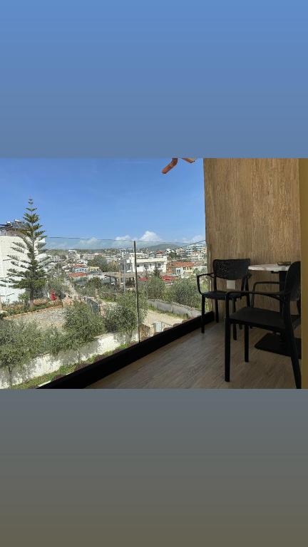 a table and chairs on a balcony with a view at Villa White in Ksamil