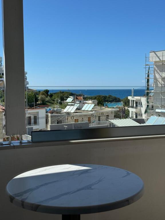 a table in front of a window with a view at Villa White in Ksamil