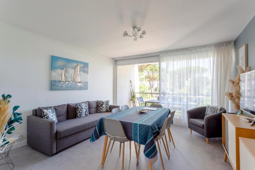 un salon avec un canapé et une table dans l'établissement Chez Marylène - Spacieux appartement proche des plages & commerces, à La Grande Motte
