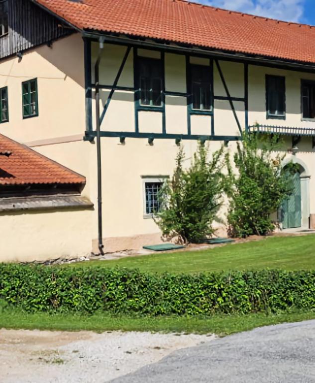 a white house with a red roof at Apartma 5 in Radovljica