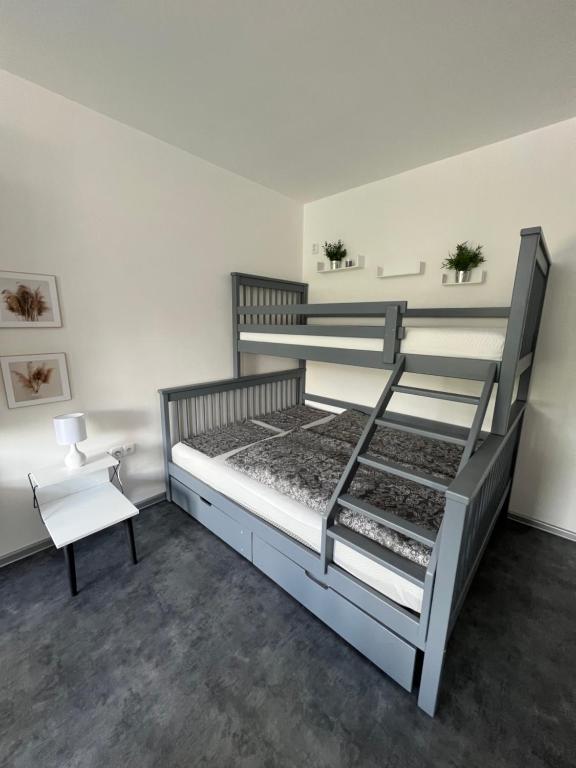 a bedroom with two bunk beds and a chair at Apartmán v centru Trutnova in Trutnov