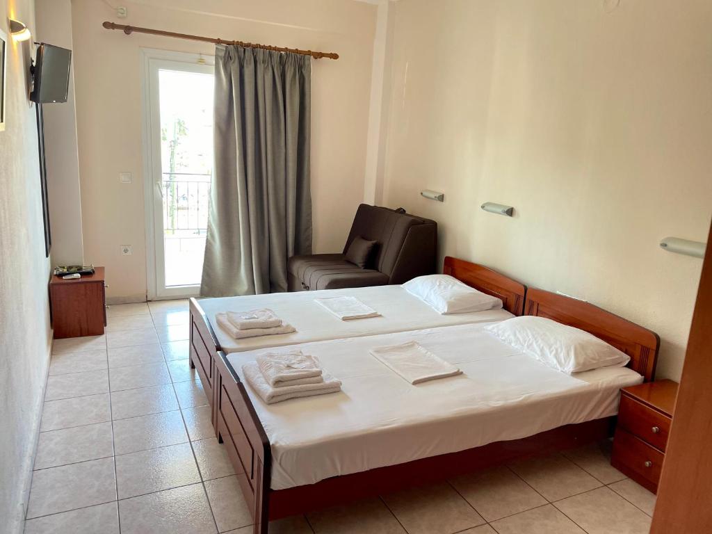 Postel nebo postele na pokoji v ubytování Hotel Evagelia