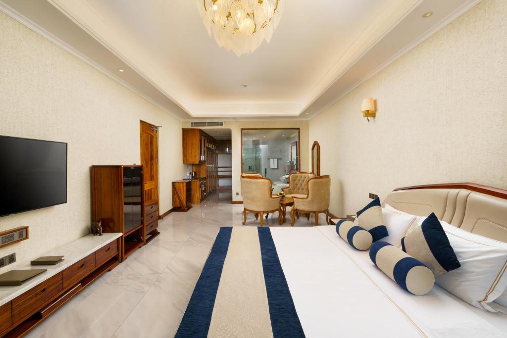 a hotel room with a bed and a television at Araliya Beach Resort & Spa Unawatuna- Where you meet the sea all year in Unawatuna