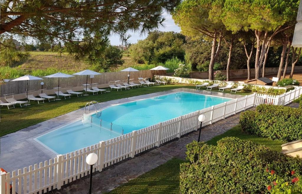 una vista aérea de una piscina con sillas y una valla en Villaggio Mietta, en Castiglioncello