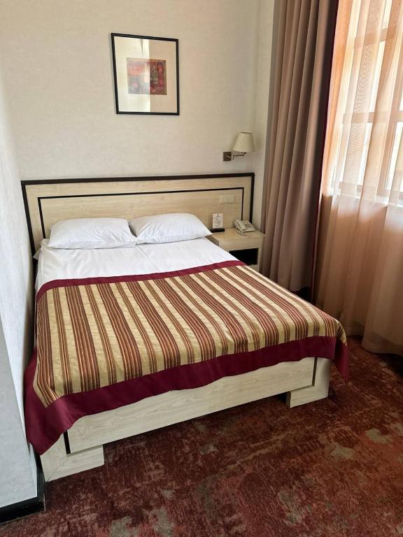 Postel nebo postele na pokoji v ubytování Hotel Rike park
