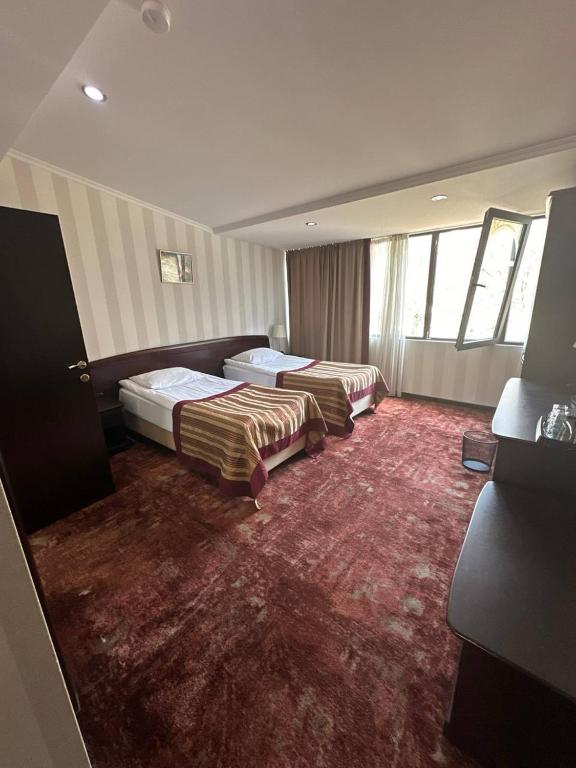 Postel nebo postele na pokoji v ubytování Hotel Rike park