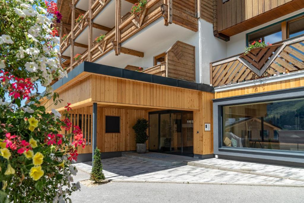 an exterior view of a building with a large glass door at Ferienalm Panorama Apartments in Schladming