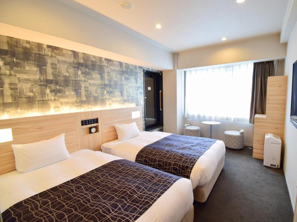 Postel nebo postele na pokoji v ubytování APA Hotel Kyoto Gojo Omiya