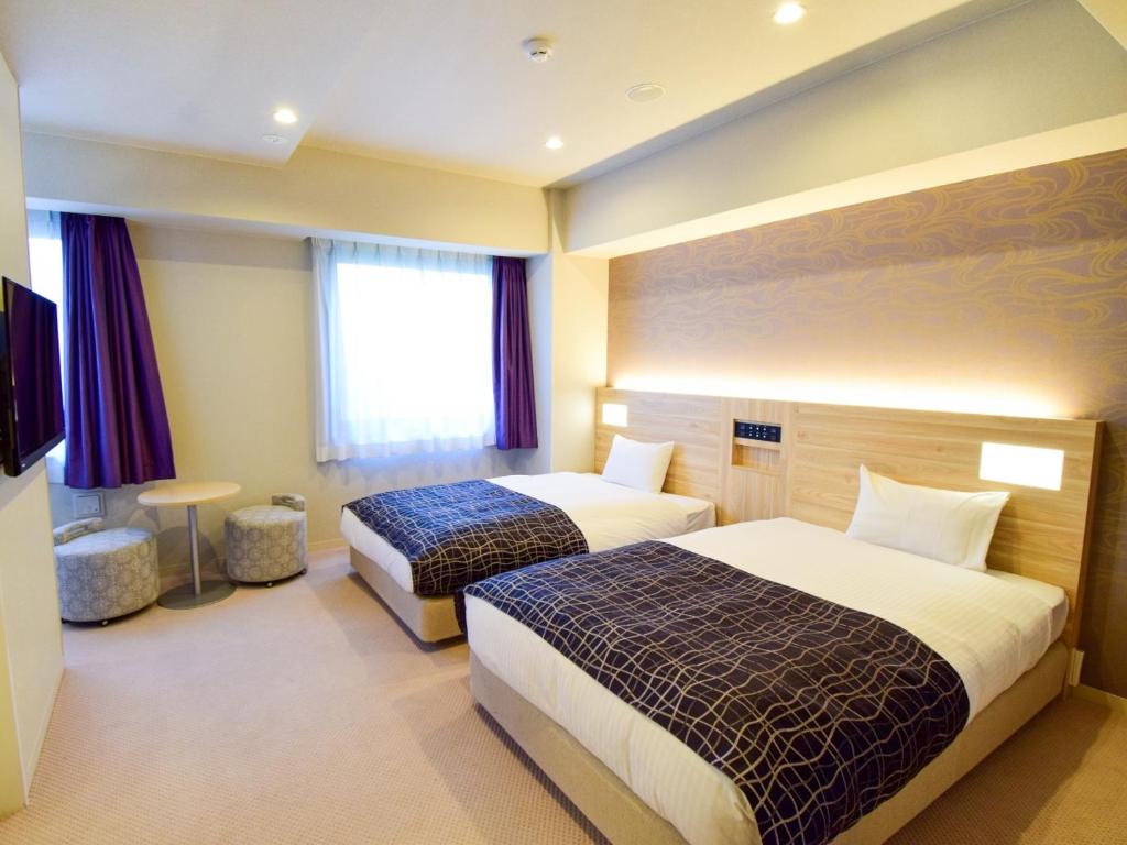 Postel nebo postele na pokoji v ubytování APA Hotel Kyoto Gojo Omiya