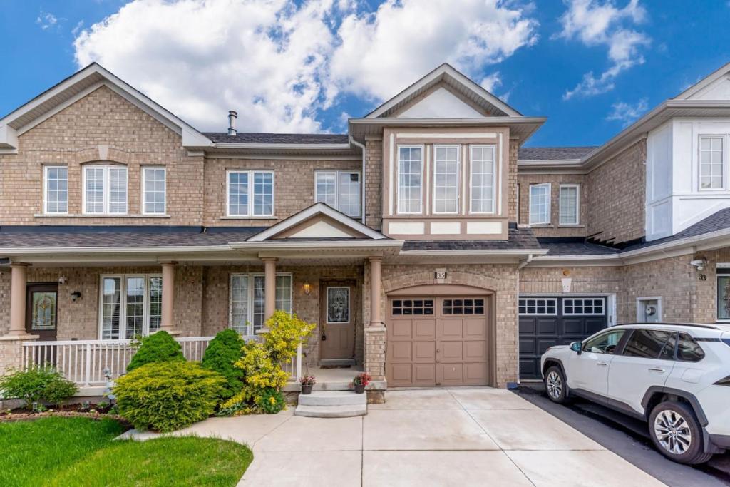 a house with a car parked in front of it at Brampton Retreat - Quiet 2BR Residential Area in Brampton
