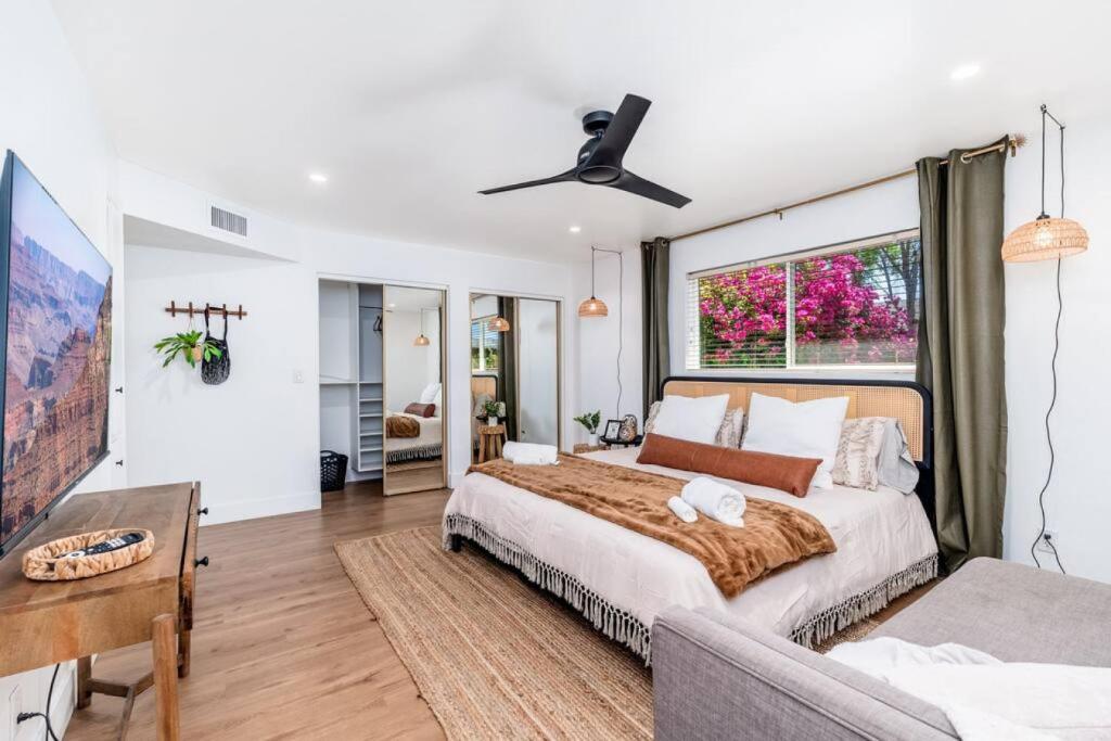 a bedroom with a large bed and a window at Sunshine, Paradise Escape! Private Pool, Sleeps 12 in Phoenix
