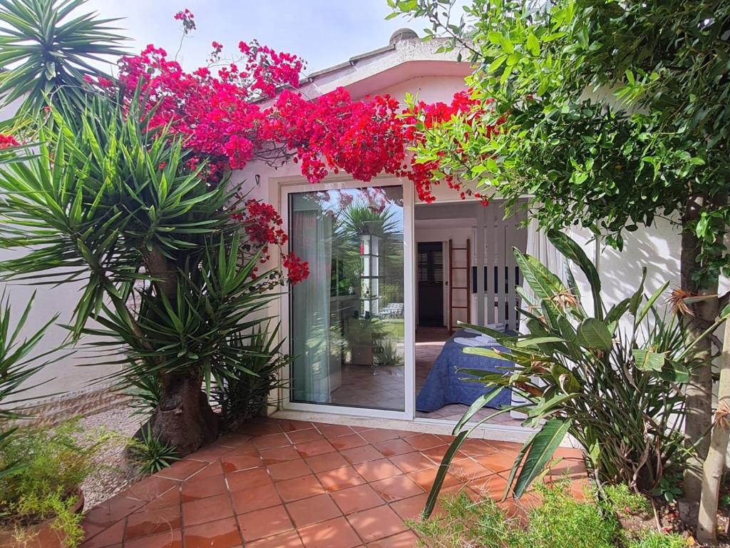 a house with pink flowers on the front of it at Dependance in Villa in San Felice Circeo