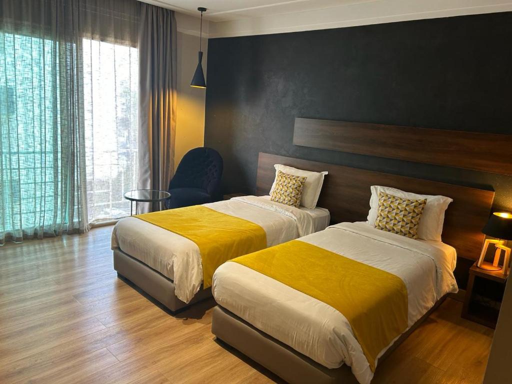 Postel nebo postele na pokoji v ubytování Yto boutique Hotel