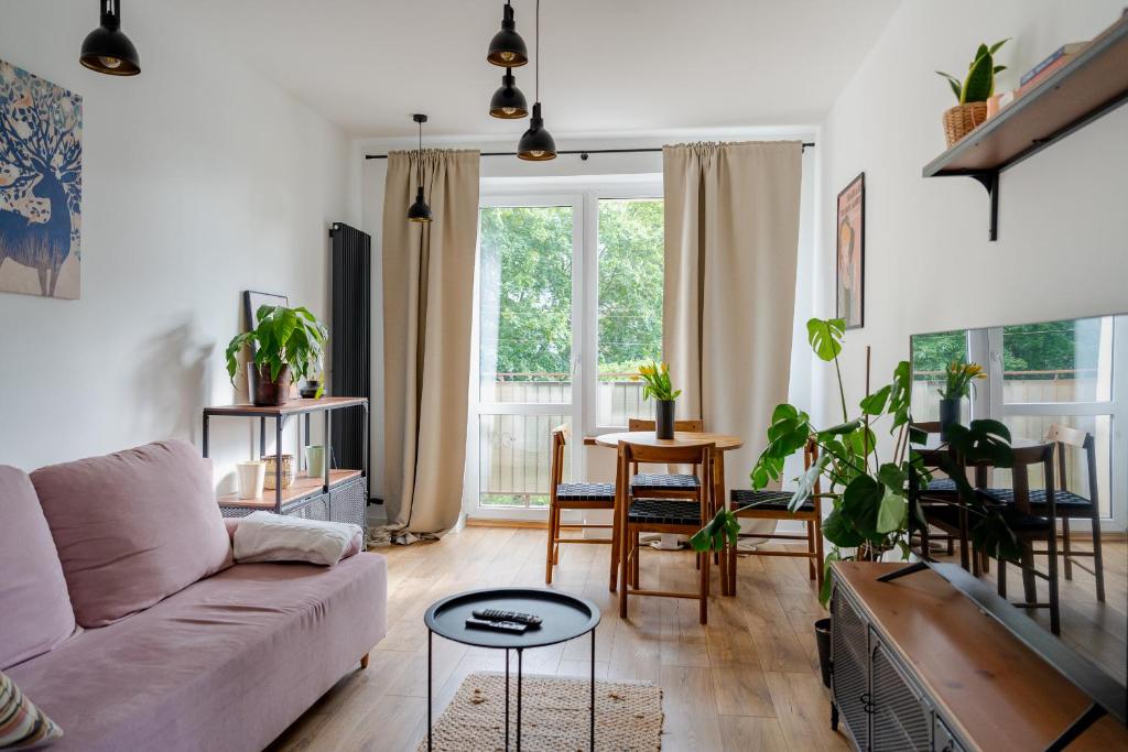 ein Wohnzimmer mit einem Sofa und einem Tisch in der Unterkunft Apartament Fika - klimatyczny w centrum miasta by SpaceApart in Jelenia Góra