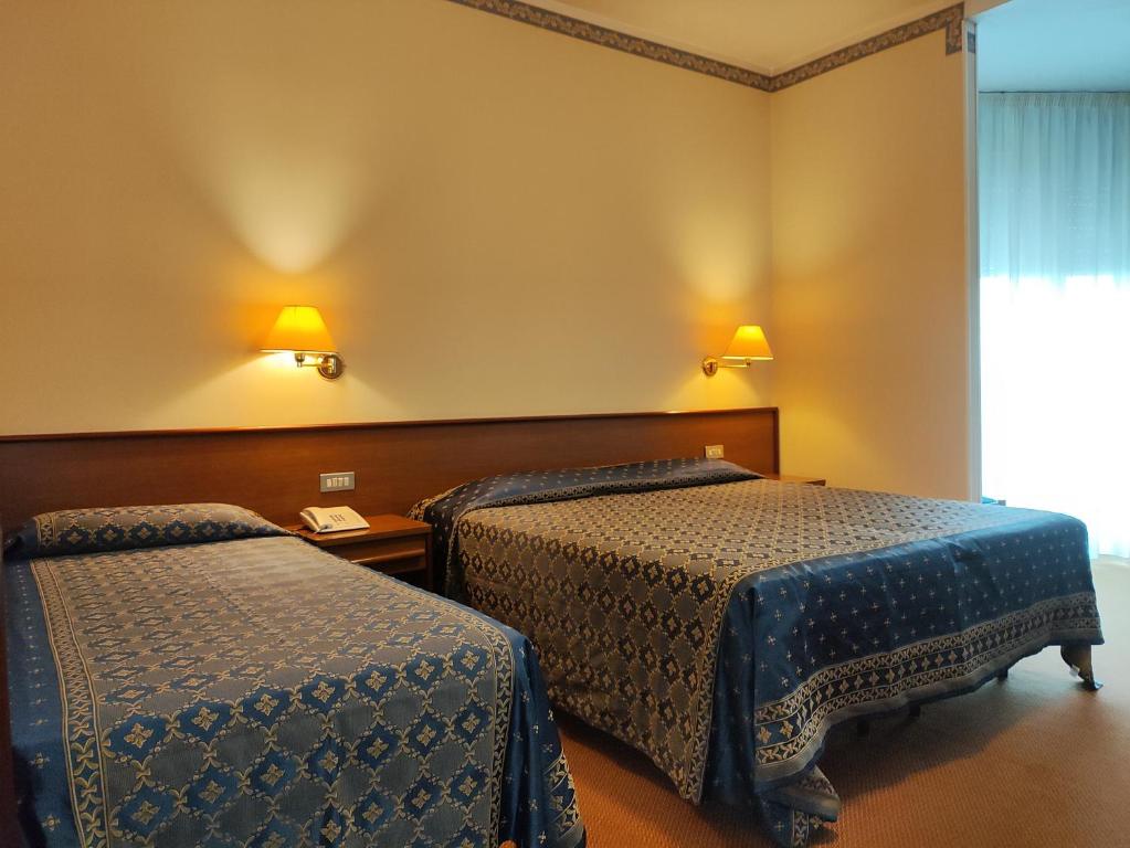 Postel nebo postele na pokoji v ubytování Hotel Firenze