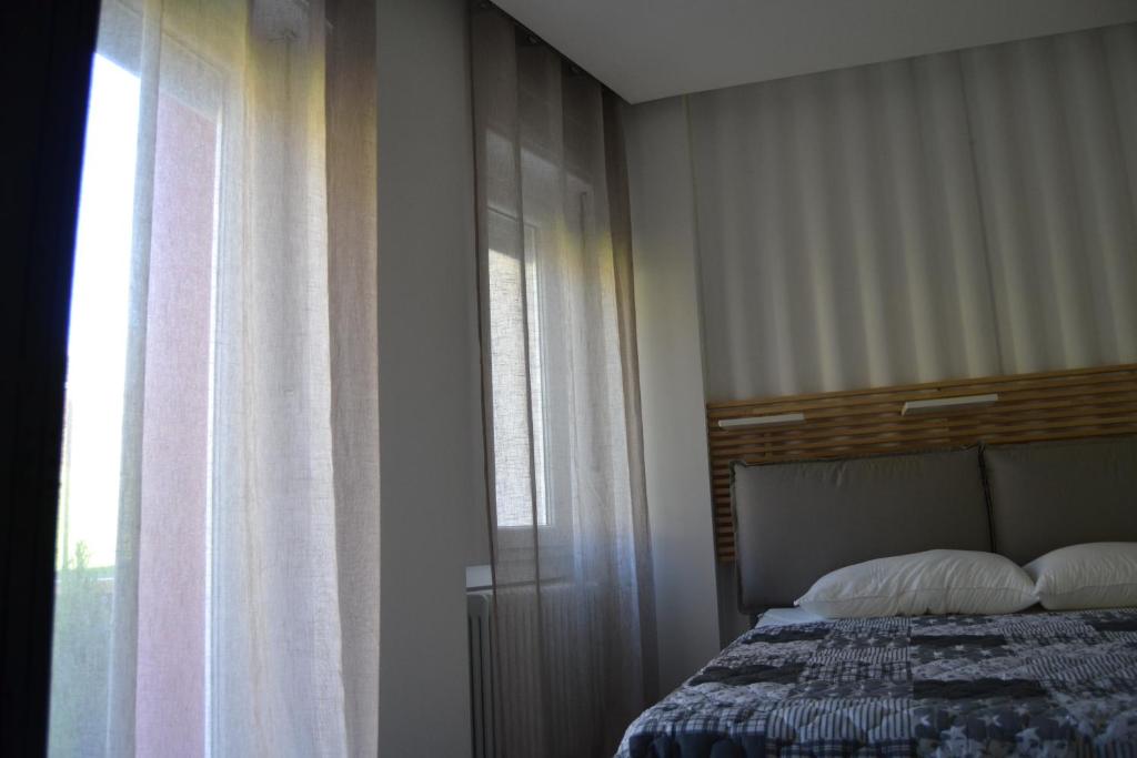 Postel nebo postele na pokoji v ubytování SMILE ACCOMODATION AOSTA