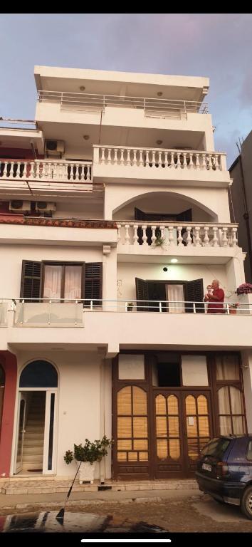 a large white building with a balcony on top of it at Pipo apartmentS in Ulcinj