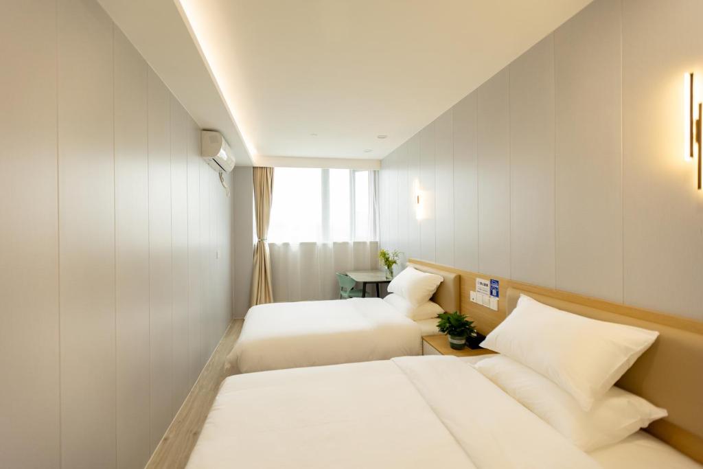 Postel nebo postele na pokoji v ubytování KeTangJian Aparthotel