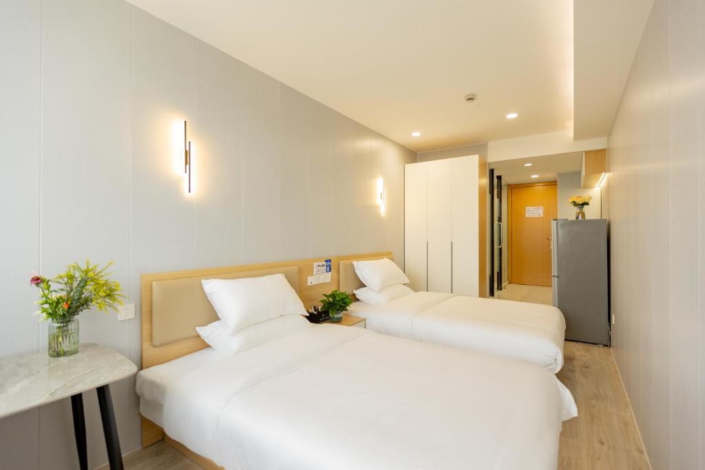 Postel nebo postele na pokoji v ubytování KeTangJian Aparthotel
