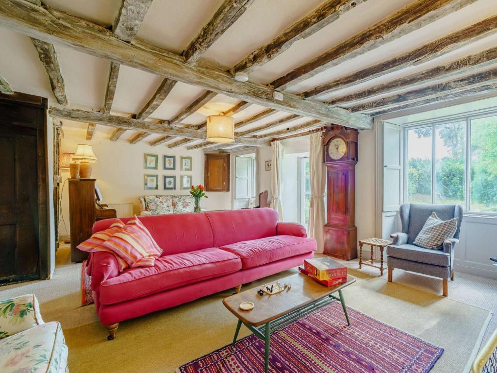 a living room with a red couch and a table at 5 Bed in Broughton Beck SZ587 in Spark Bridge