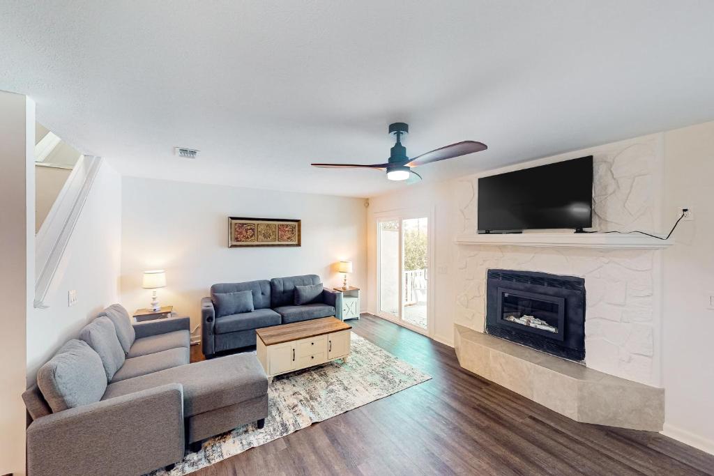 a living room with a couch and a fireplace at Life on the Lagoon in Panama City