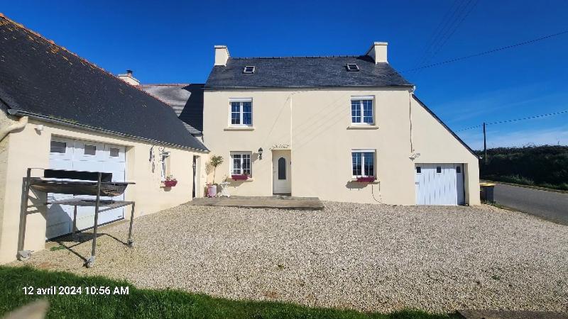 une grande maison blanche avec une grande allée dans l'établissement Maison avec 3 chambres parentales, à Plouénan