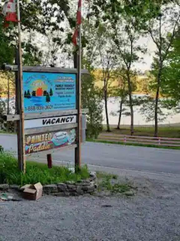 a sign on the side of a road at Lakefront Hideaway Resort 10 Total cabins-Lake View, Private Beach in Kawartha Lakes