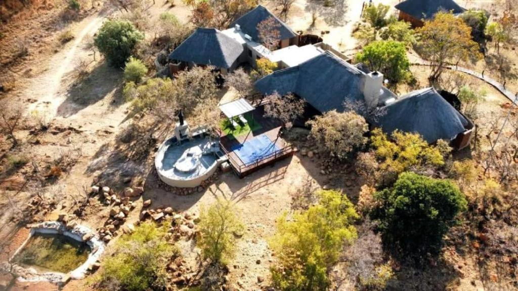 an aerial view of a house with a boat in the yard at Livingstone Bush Lodge, Mabalingwe in Bela-Bela