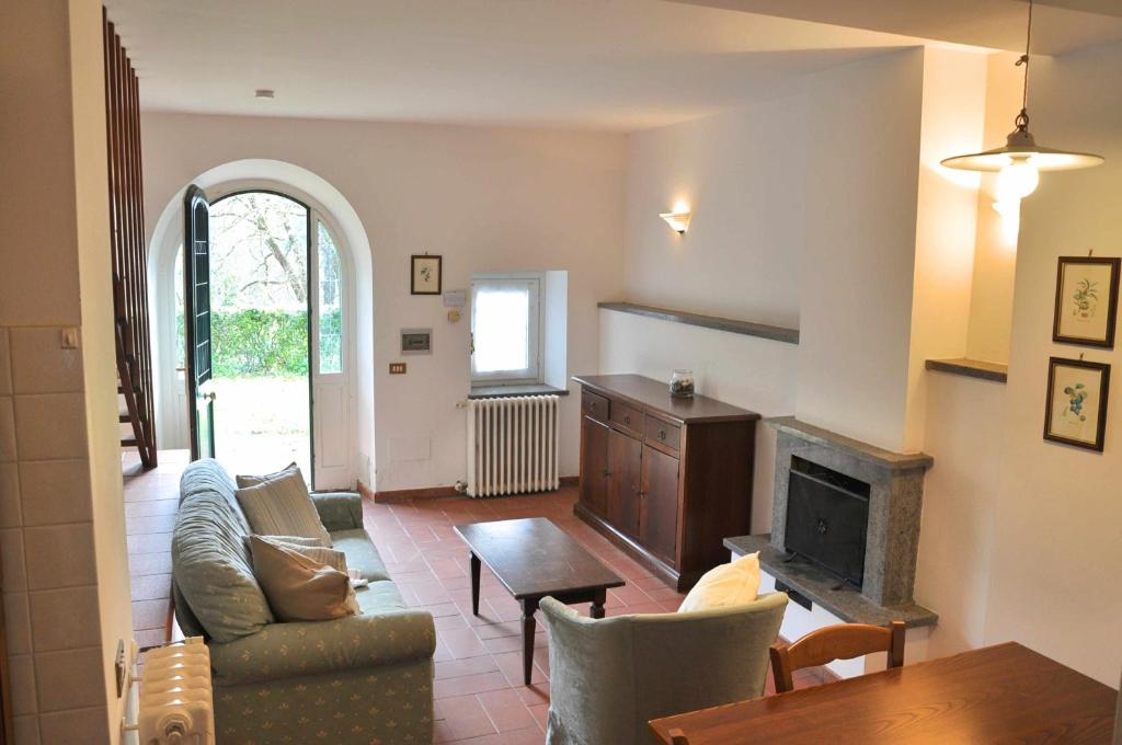 a living room with a couch and a fireplace at Montecasciano - Rosa in Capranica