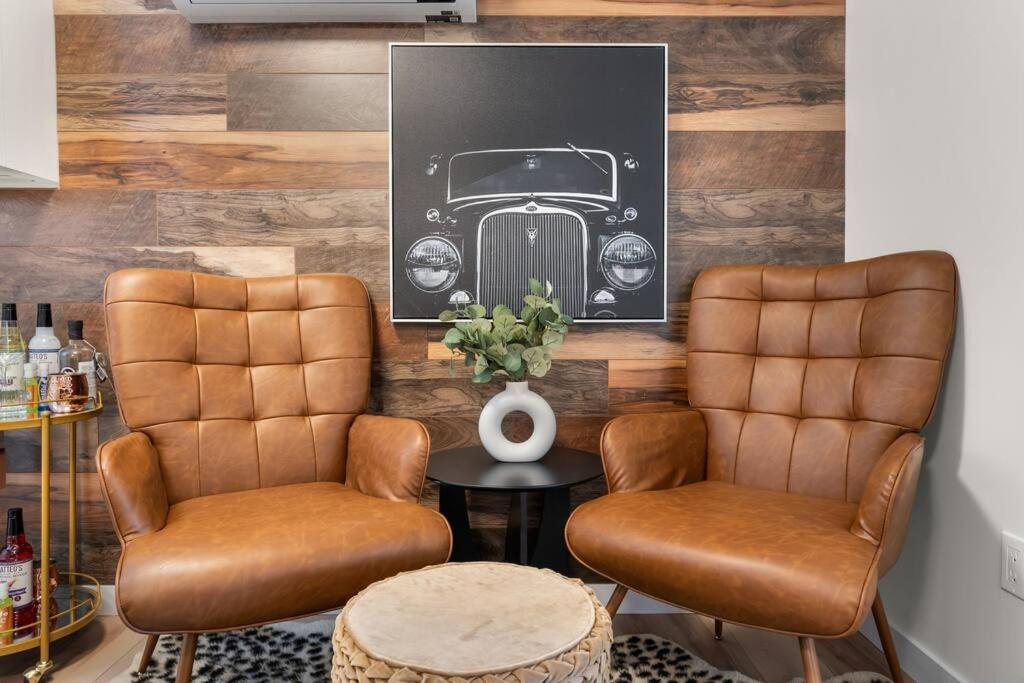 a salon with two chairs and a picture of a car at Dieppe Charm Suites, 2 BDRM, Walk to Local Market in Dieppe