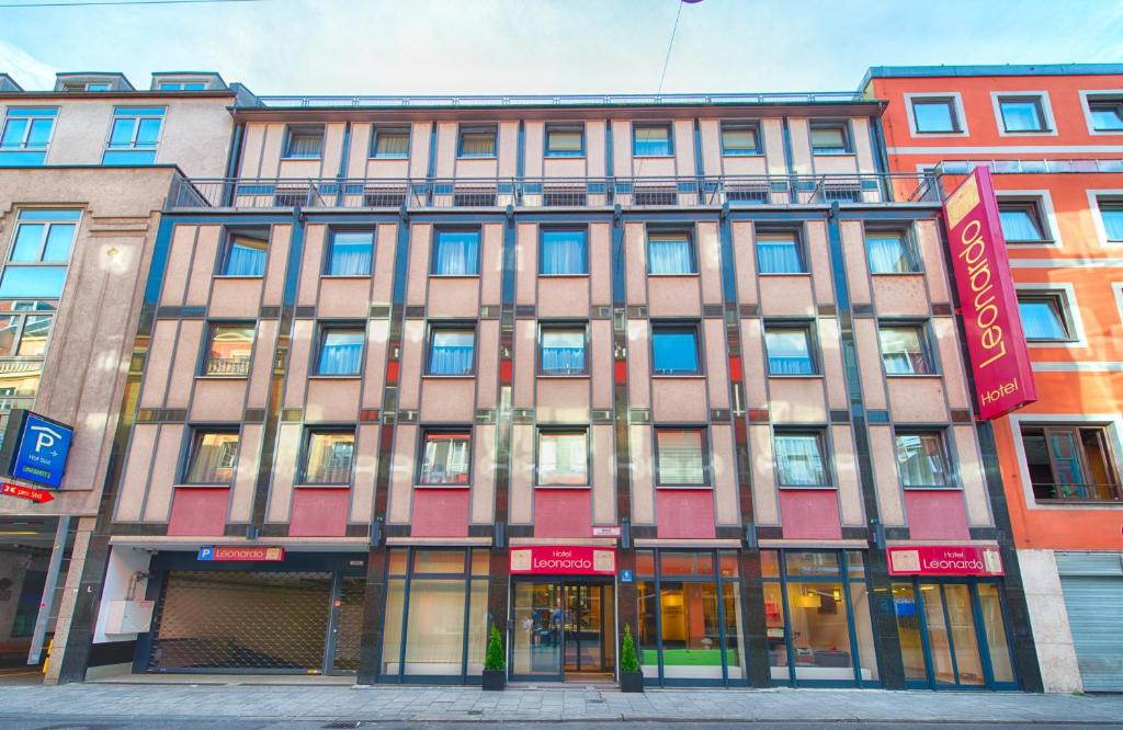 a building on the corner of a street at Leonardo Hotel München City Center in Munich