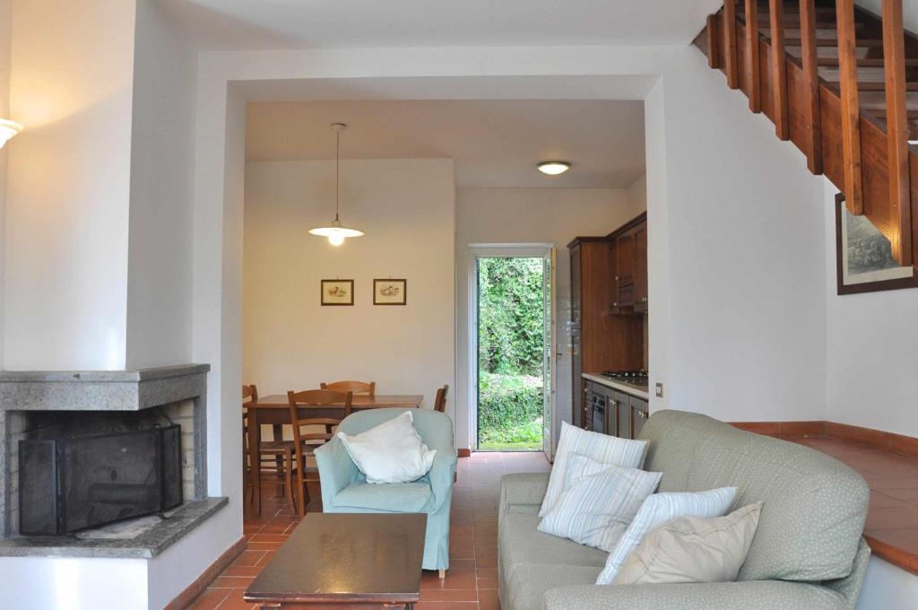 a living room with a couch and a fireplace at Montecasciano - Margherita in Capranica