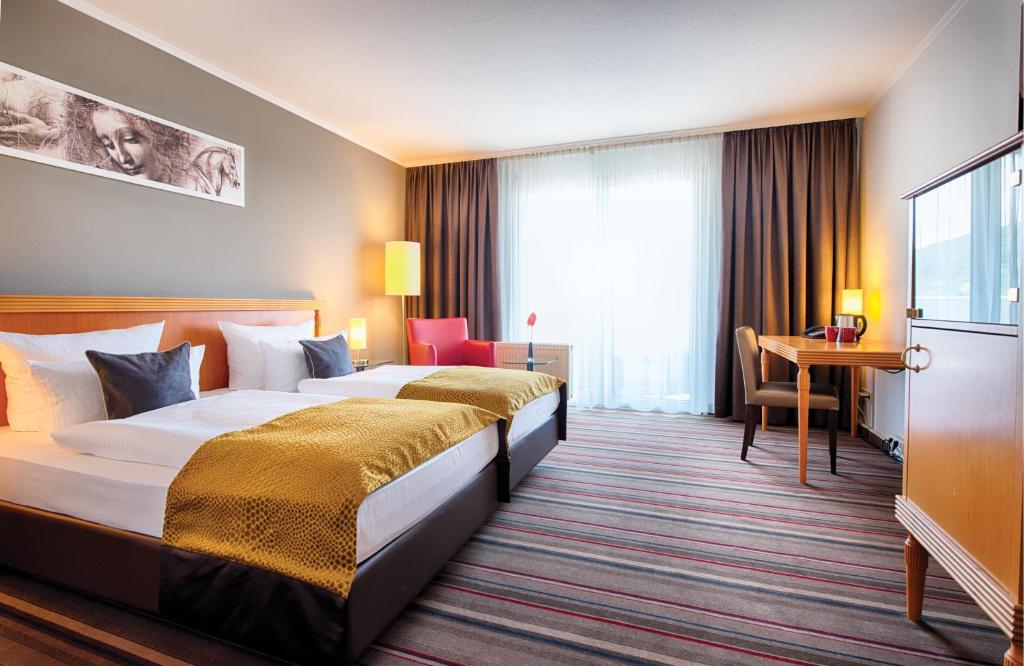 Säng eller sängar i ett rum på Leonardo Hotel Heidelberg City Center