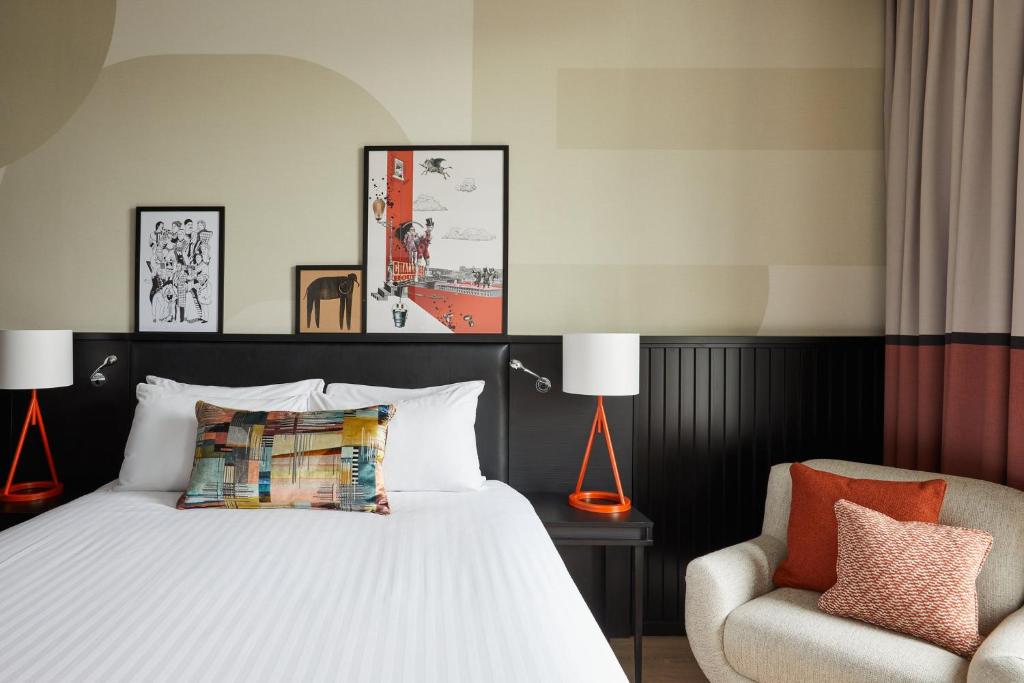 a bedroom with a bed and a chair at Hotel Indigo Newcastle by IHG in Newcastle upon Tyne