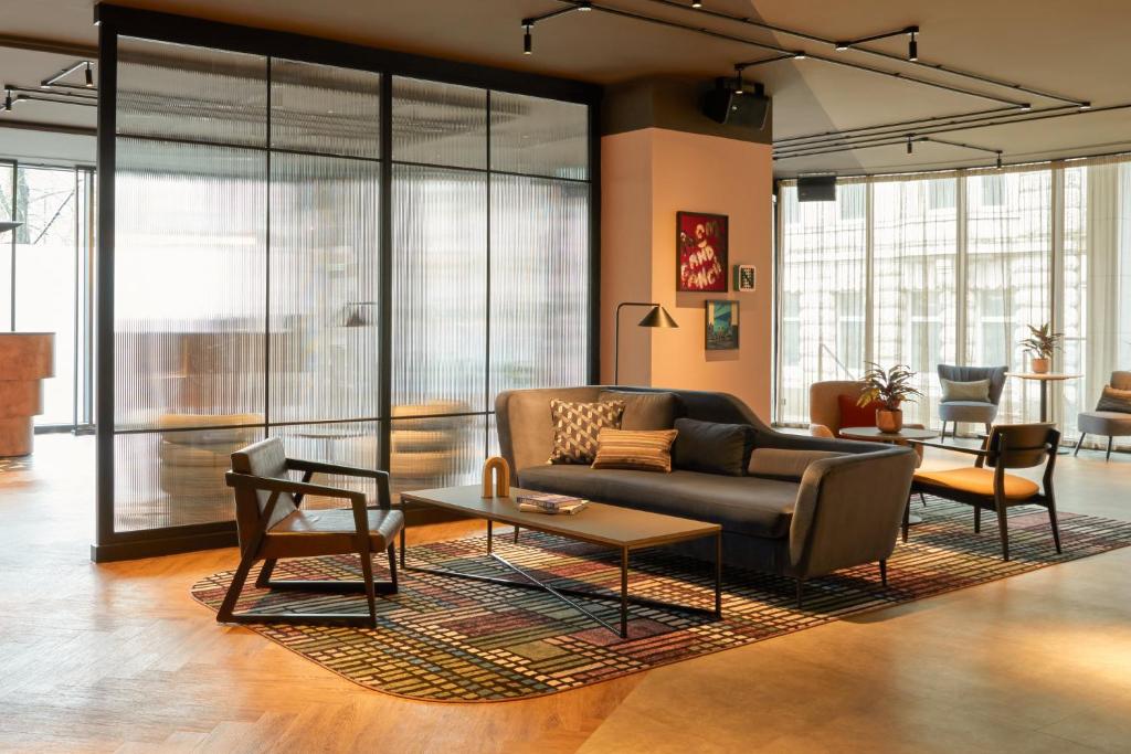 a living room with a couch and chairs at Hotel Indigo Newcastle, an IHG Hotel in Newcastle upon Tyne