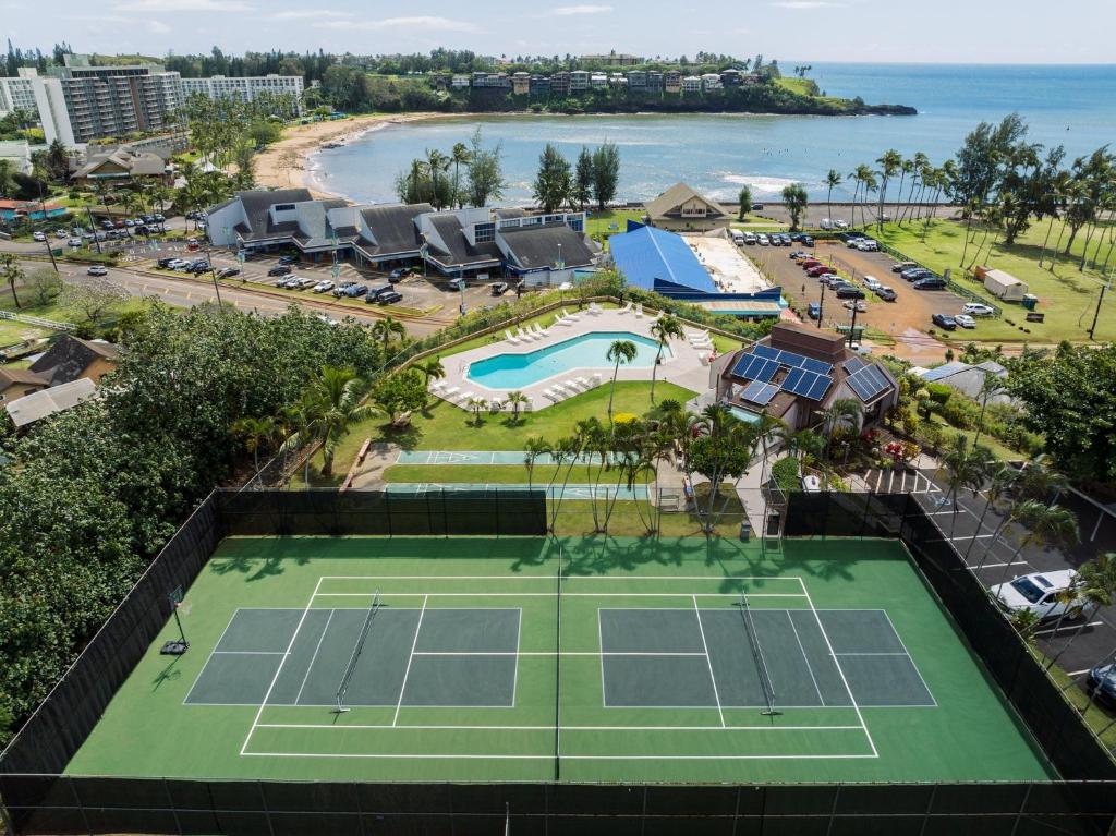 an aerial view of a tennis court and the beach at Banyan Harbor Resort in Lihue