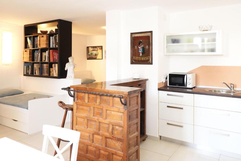 a kitchen with a wooden cabinet and a microwave at Apartment Istra in Poreč