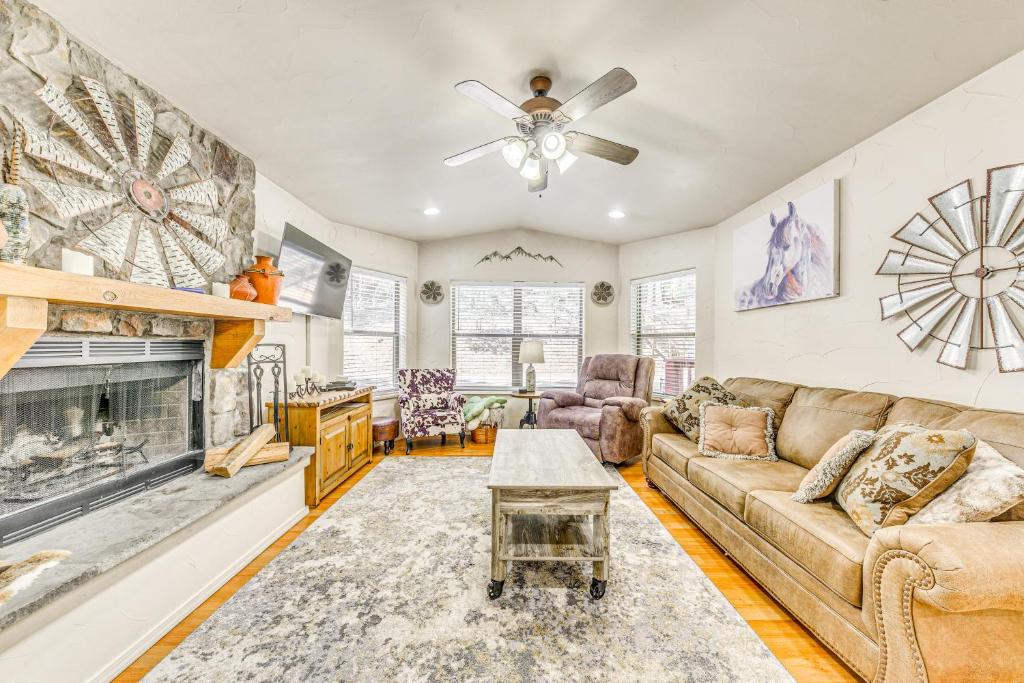 a living room with a couch and a fireplace at Ruidoso Cabin Rental with Hot Tub Near Midtown! in Ruidoso