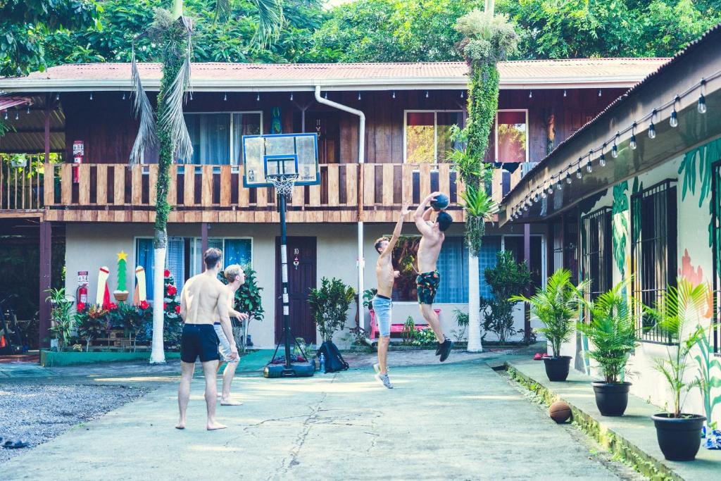 a group of men playing a game of basketball at Rio Danta Hostel in Fortuna