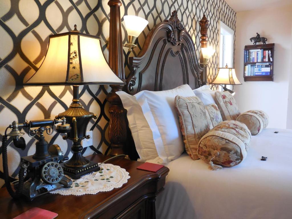 a bedroom with a bed with a lamp on a table at Crystal Springs B&B in Killarney