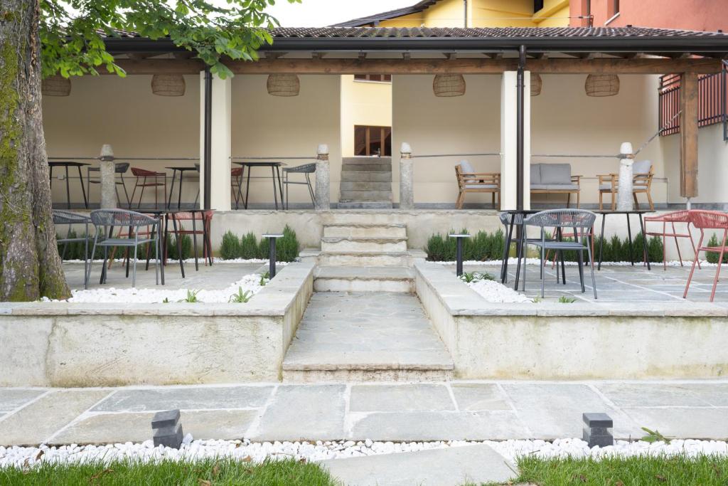 a patio with tables and chairs and a table at Villa Il Platano in Como