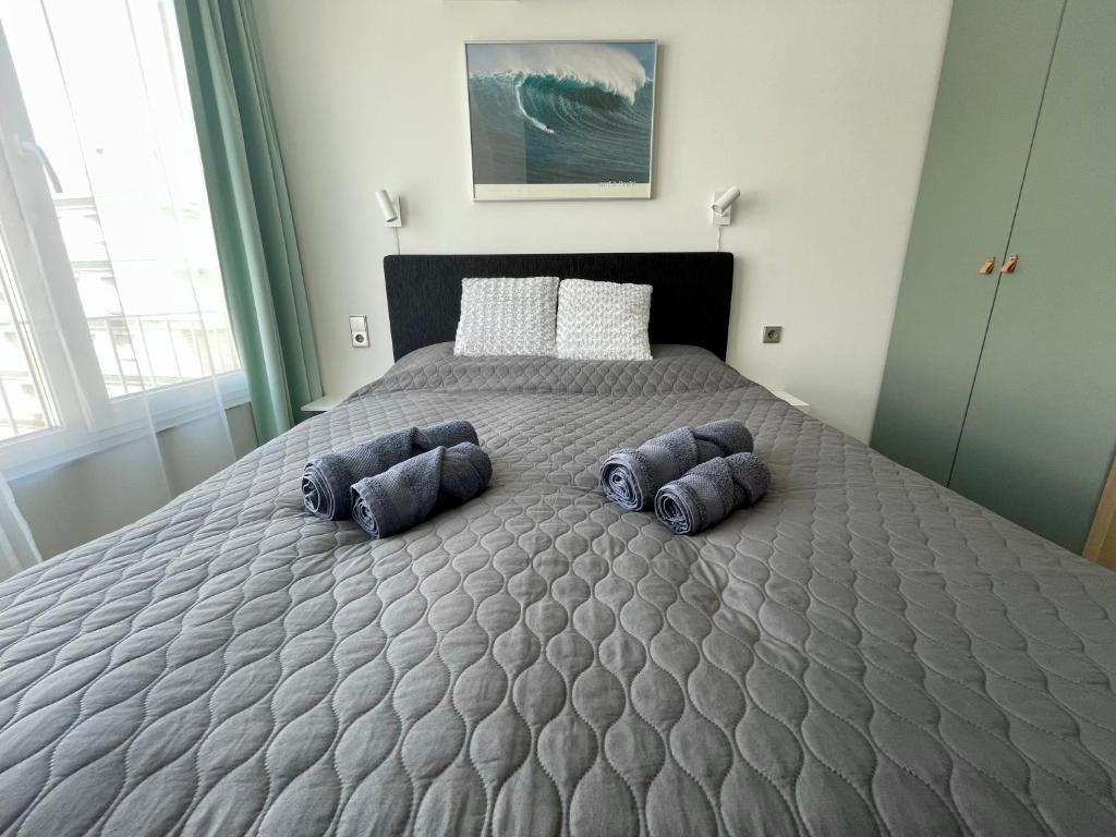 a bedroom with a bed with three blue pillows on it at Sea Side apartments in Santa Pola