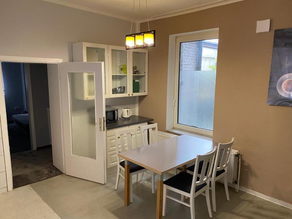 a kitchen with a table and chairs and a window at Apartment in Herne 4 in Herne