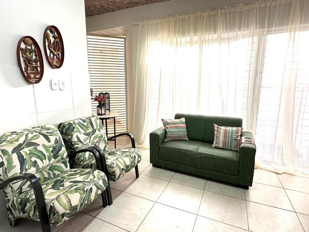 a living room with a couch and a chair at Fique no Centro de Petrolina in Petrolina