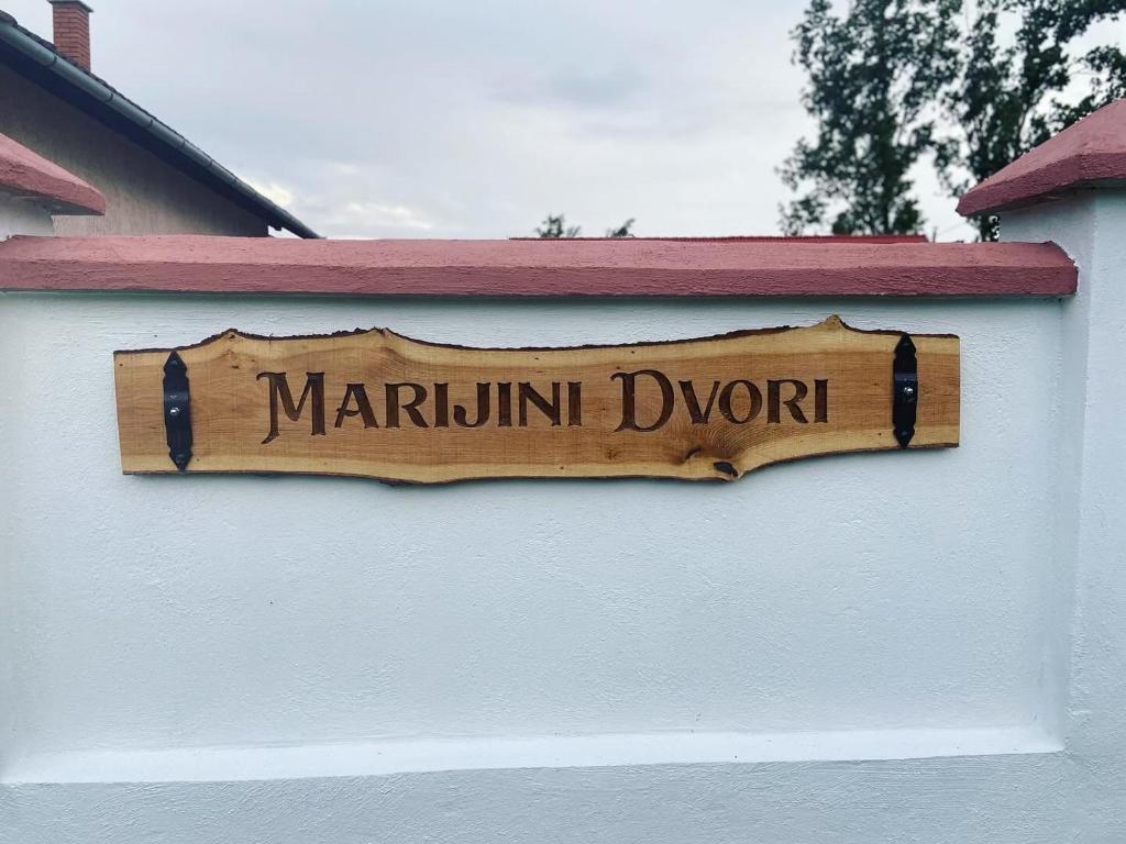 a wooden sign on the side of a building at Marijini dvori in Čadjavica