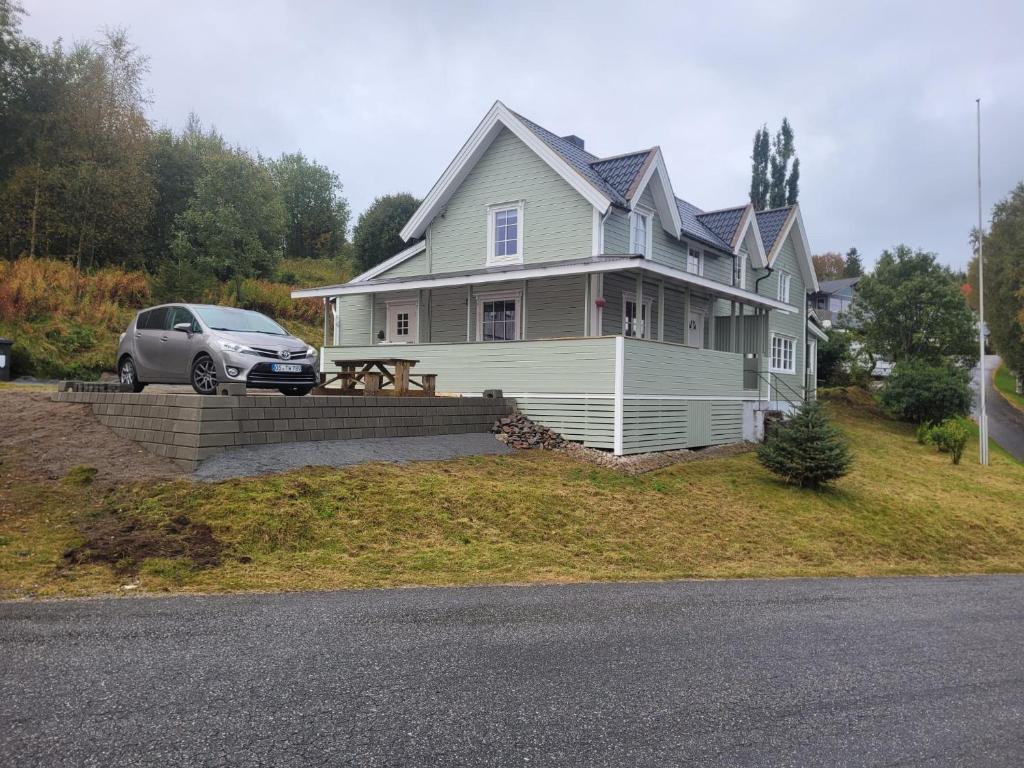 a house with a car parked in front of it at Ferienhaus Solli Norwegen inkl Boot in Kolvereid