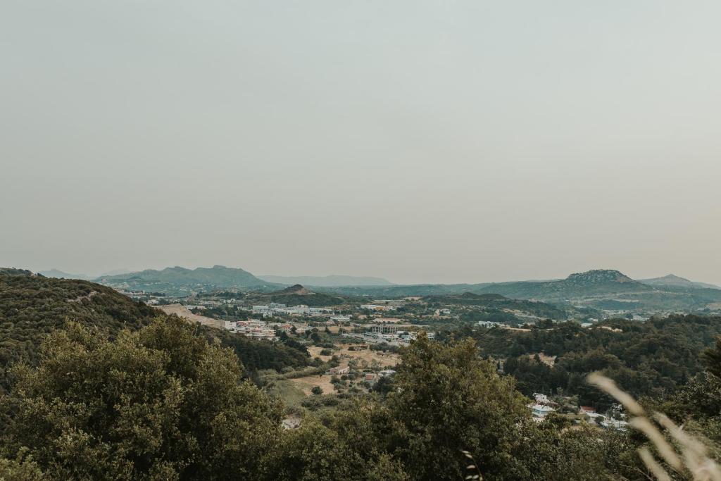 a view of a city from the hills at Maya pool & mountain view villa in Koskinou