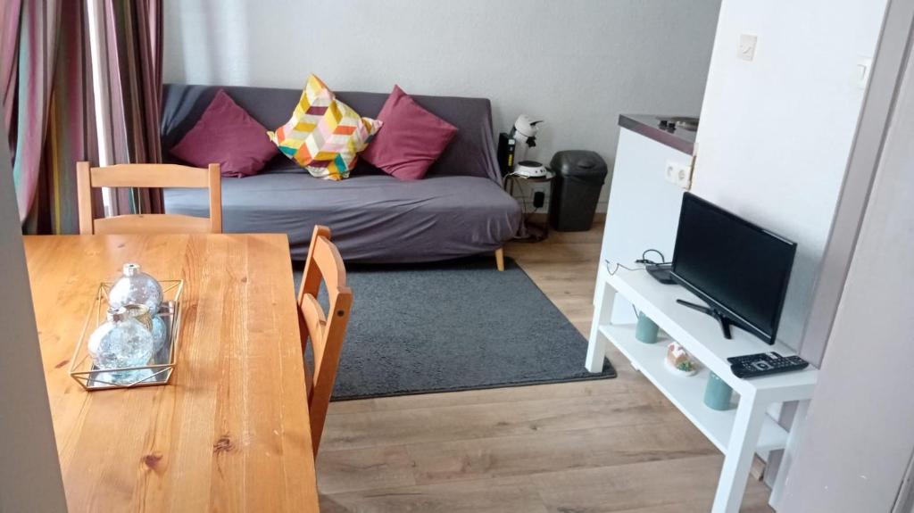 a living room with a table and a couch at Hyper centre Strasbourg in Strasbourg