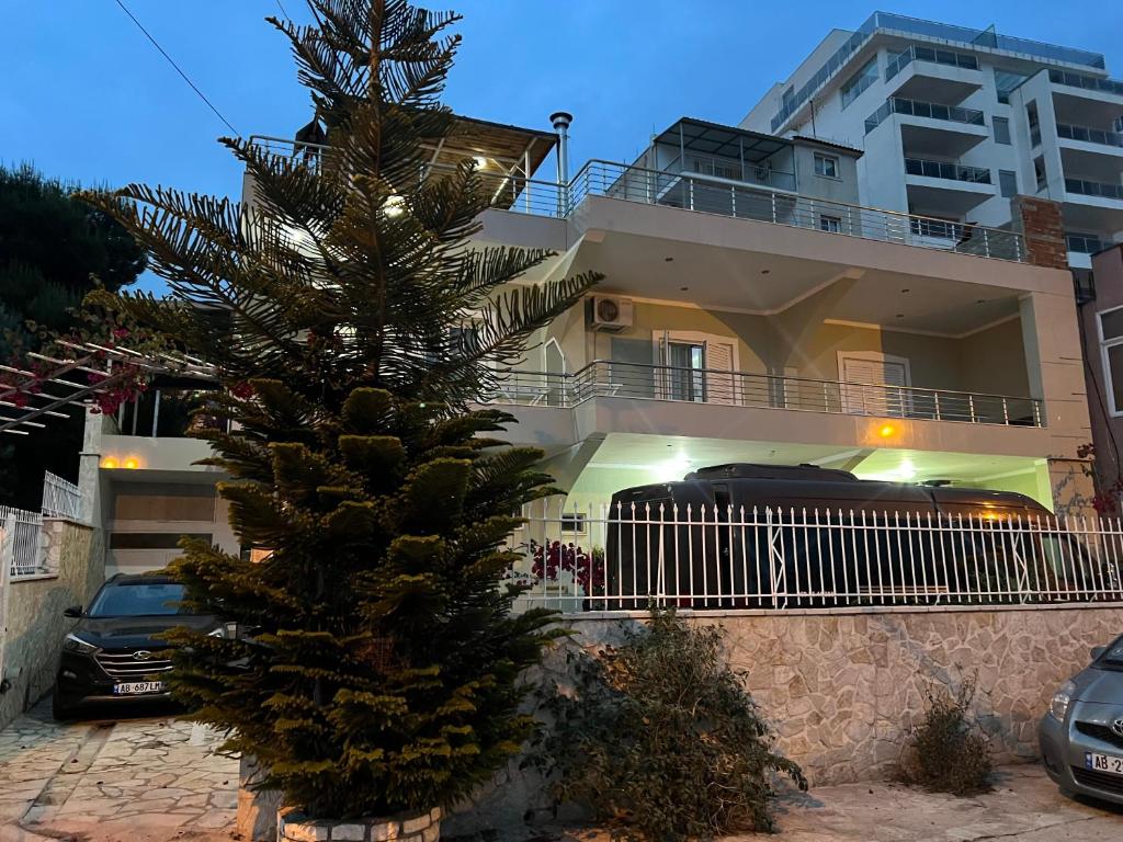 a christmas tree in front of a building at Villa AlMar in Sarandë